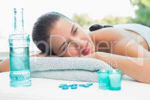 Woman lying on massage table at spa center