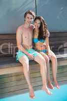 Romantic young couple by swimming pool