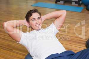 Man doing sit up on exercise ball