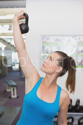 Fit brunette working out with kettlebell