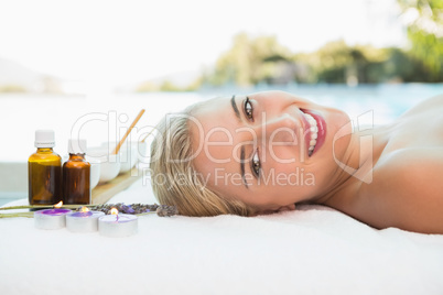 Beautiful woman lying on massage table at spa center