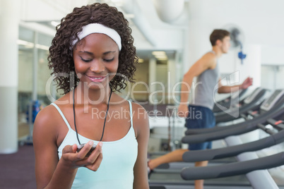 Pretty trainer looking at her stopwatch