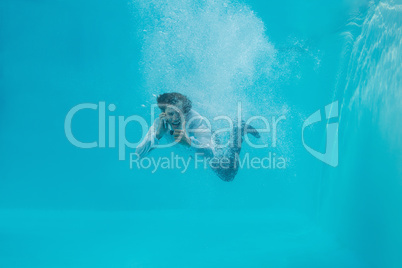 Young man swimming underwater