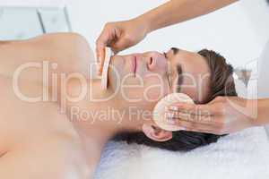 Man receiving facial massage at spa center