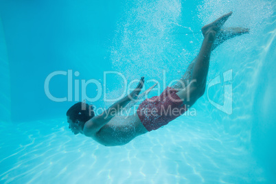 Young man swimming underwater