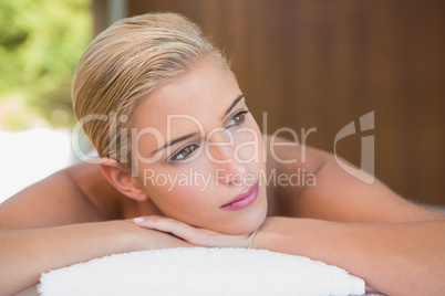 Beautiful woman lying on massage table at spa center