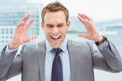 Angry young businessman at office