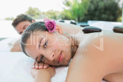 Couple enjoying stone massage at health farm