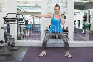 Fit brunette working out with kettlebell