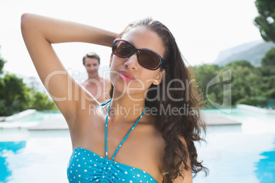 Beautiful young woman by swimming pool