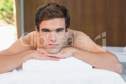 Man lying on massage table at spa center