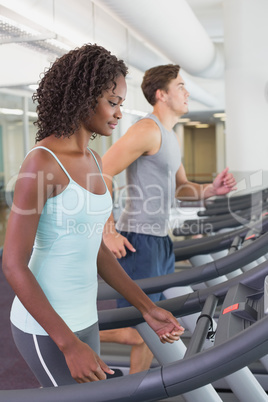 Fit people running on treadmills