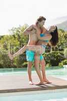 Romantic young couple by swimming pool