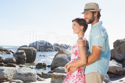 Gorgeous couple embracing by the coast