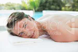 Handsome man lying on massage table at spa center