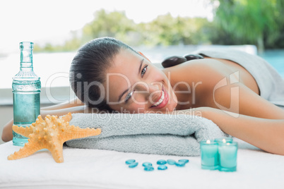 Beautiful woman lying on massage table at spa center