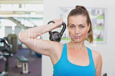 Fit brunette working out with kettlebell