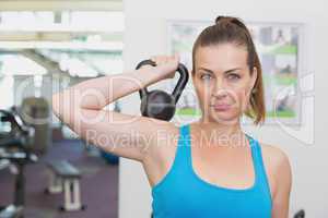 Fit brunette working out with kettlebell