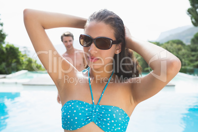 Beautiful woman by swimming pool on a sunny day