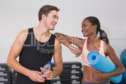 Personal trainer and client smiling at each other