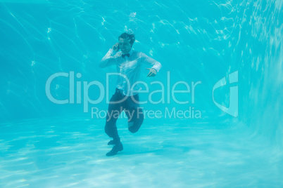 Young man swimming underwater