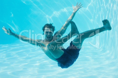 Young man swimming underwater