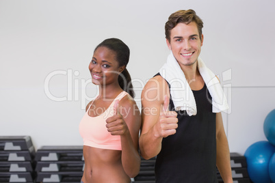 Personal trainer and client smiling at camera