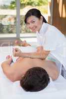 Man receiving back massage at spa center