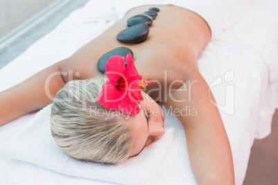 Woman receiving stone massage at health farm