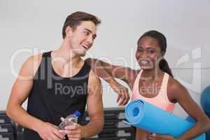 Personal trainer and client smiling at camera