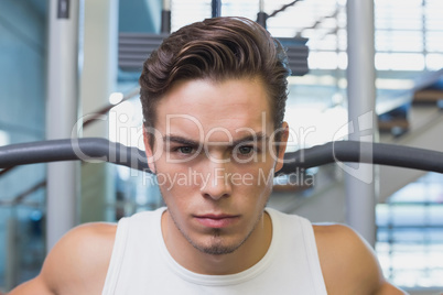 Strong man using weights machine for arms