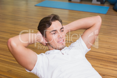 Man doing sit up on exercise ball