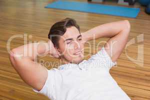 Man doing sit up on exercise ball