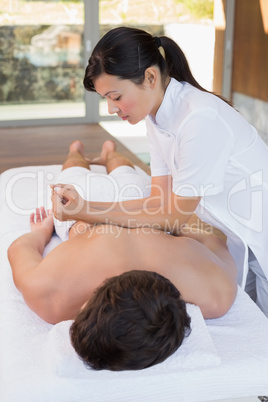 Man receiving back massage at spa center