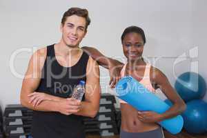 Personal trainer and client smiling at camera