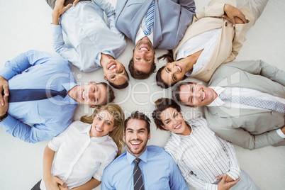 Young business people lying in circle