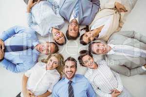 Young business people lying in circle