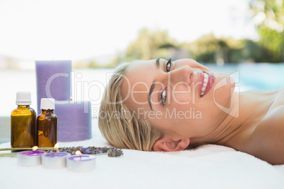 Beautiful woman lying on massage table at spa center