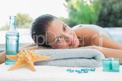 Beautiful woman lying on massage table at spa center