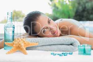 Beautiful woman lying on massage table at spa center