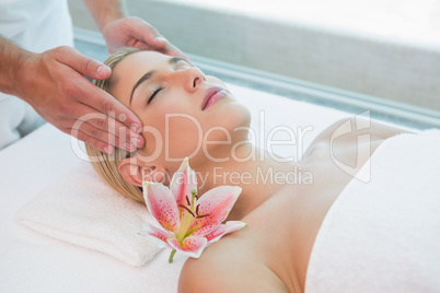 Attractive woman receiving head massage at spa center