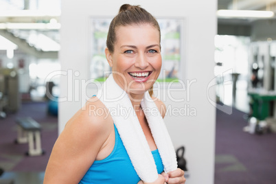 Fit brunette smiling at camera in fitness studio Fit brunette smiling at camera in fitness studio