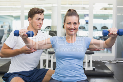 Personal trainer working with client on exercise ball