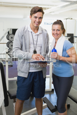 Personal trainer and client smiling at camera