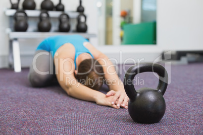 Fit brunette working out with kettlebell