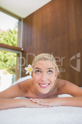 Beautiful woman lying on massage table at spa center