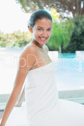 Beautiful woman sitting with eyes closed at spa center