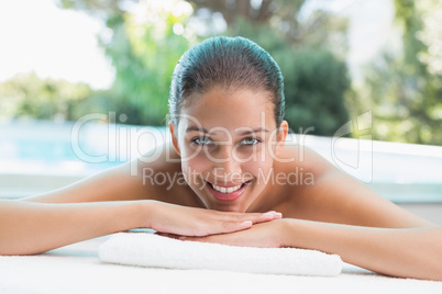 Beautiful woman lying on massage table at spa center