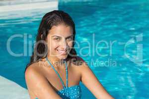 Portrait of a beautiful young woman by swimming pool