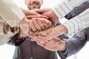 Close up of executives holding hands together